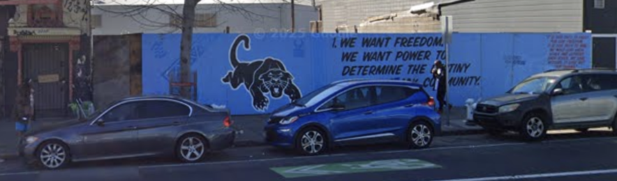 Another panther mural against a blue background, with cars parked in front and text reading, "We want freedom."